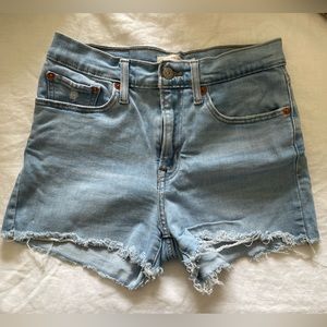 High rise Levi’s jean shorts. Size 27. Raw hem.